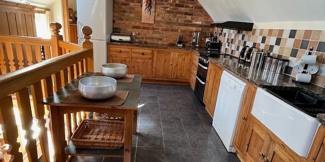 Beautiful, well equipped galleried kitchen overlooking oak staircase