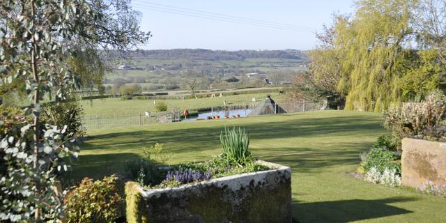 Views accross the valley from our large landscaped flower filled gardens